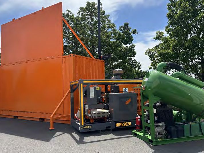 BlastOne orange container and green pump unit on display outdoors