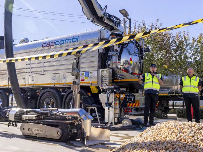 KOR Equipment Solutions crew presenting a truck and tracked robotic crawler outdoors