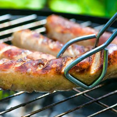 Sausages cooking on a barbecue grill