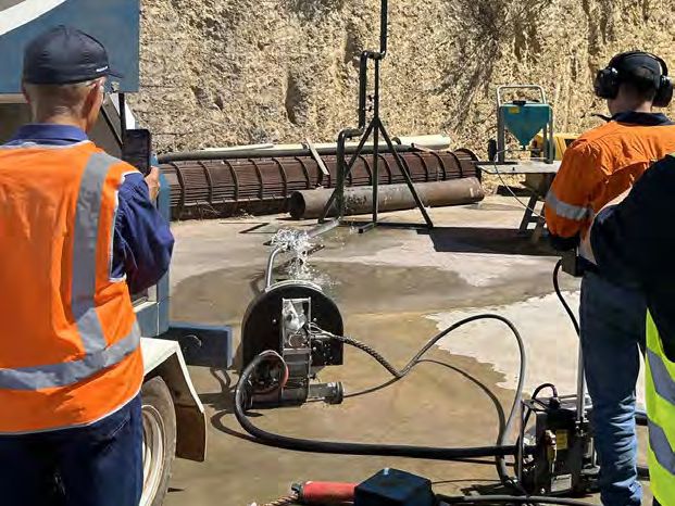 WOMA Australia demonstration with operators beside high-pressure water jetting equipment
