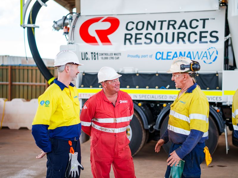 Contract Resources crew talking in front of a Contract Resources vacuum truck
