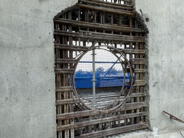 Opening cut through a concrete wall exposing steel reinforcement, by Hitech Industrial Services